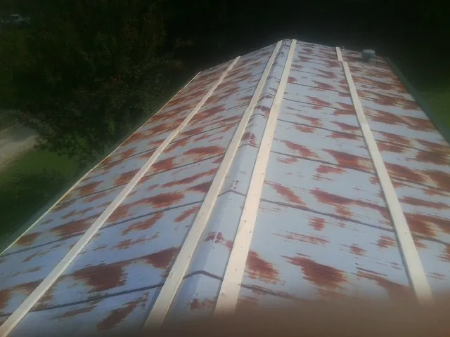 Rusted metal roof panels with new wood purlins before replacement — Storm Damage Roof Repair in Trafalgar by Roofing Brothers