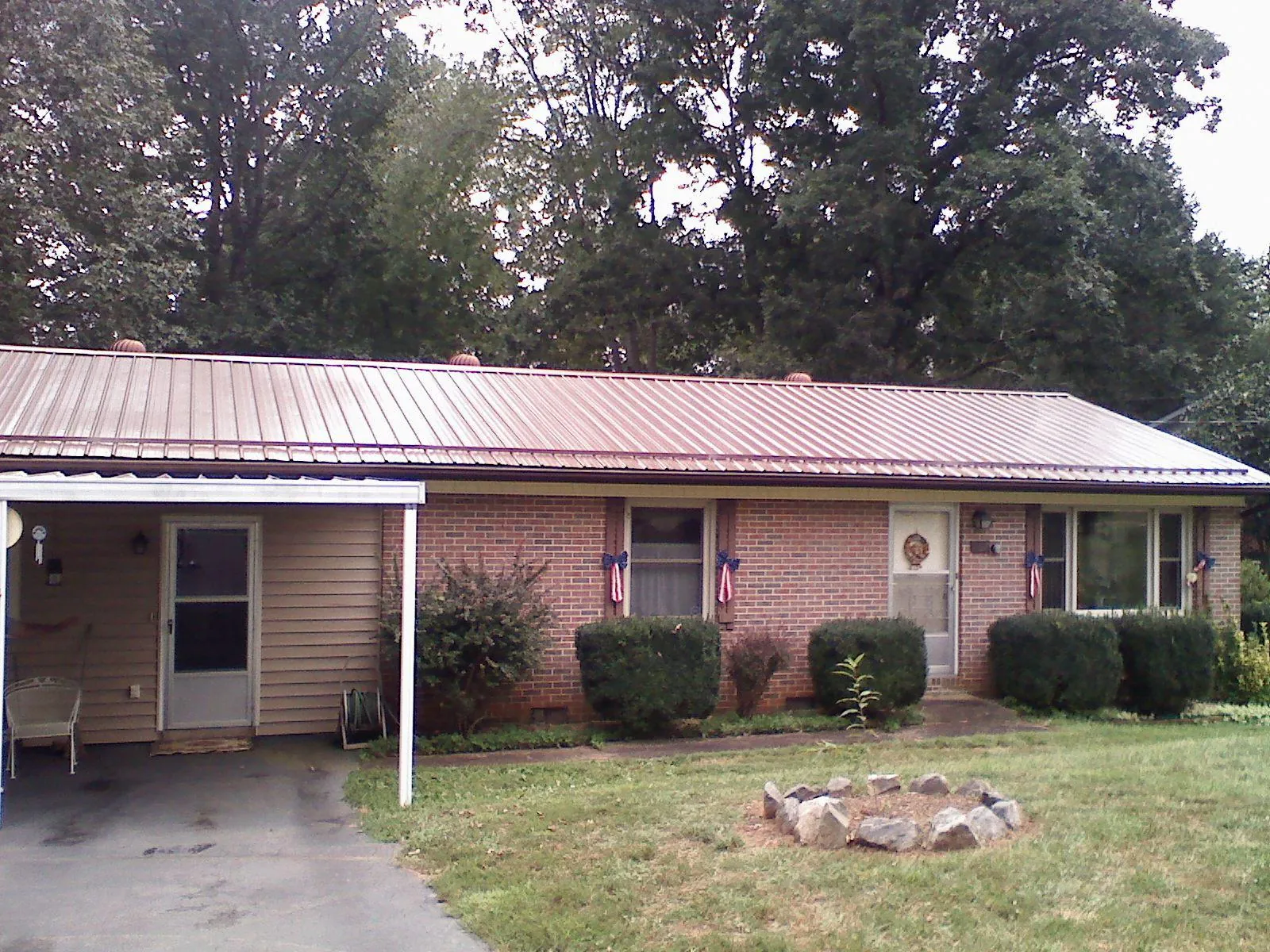 Bronze metal roof and carport on a brick ranch home — Roof Repair work by our crew in Trafalgar